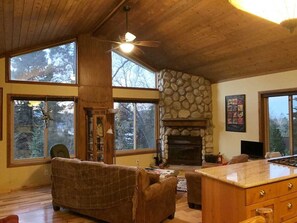 Living room, view of lake through trees.