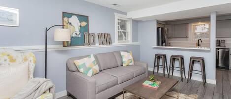 Living room with a queen pullout memory foam couch that opens up to the kitchen.