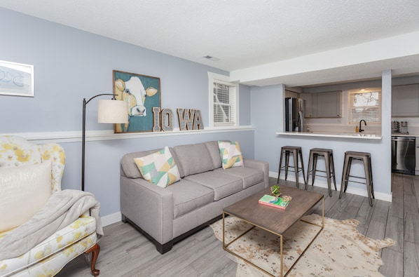 Living room with a queen pullout memory foam couch that opens up to the kitchen.