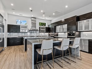 Kitchen with double islands and luxury appliances.