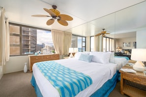 King size bed, ceiling fan, dresser and closet in this spacious bedroom