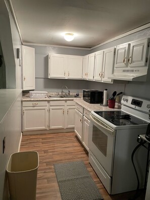 Kitchen with stove, coffee maker, toaster, microwave and doubledoor refrigerator