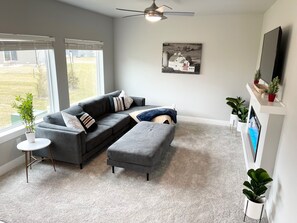 Living Room with 55 in TV, comfortable sofa and Electric Fireplace.
