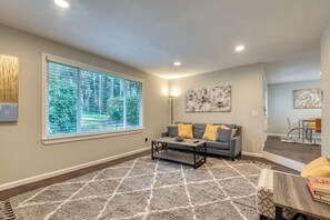 Another view of the living room with oversize window for natural light