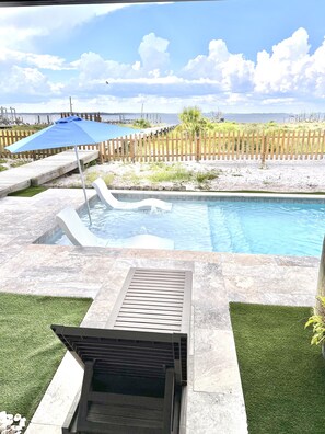 Full feature pool, tan ledge, bubblers, loungers, swim up bar, seating ledge.