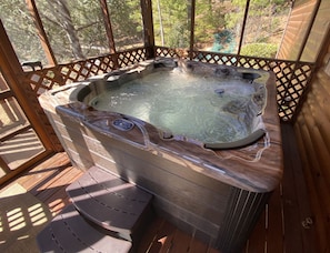 Six person jetted hot tub on the screened in porch offers a great place to relax with amazing views. 