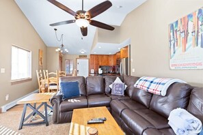 View of the family room, dining area, and fully-equipped kitchen