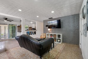 Relax in the open-concept living and kitchen area with bar.