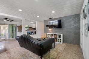 Relax in the open-concept living and kitchen area with bar.