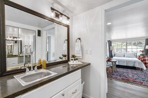 The private main bedroom has a queen bed and a large ensuite bathroom.