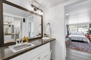 The private main bedroom has a queen bed and a large ensuite bathroom.