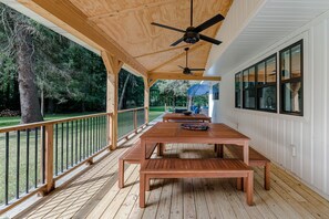 Two large dining tables and benches for outdoor dining.