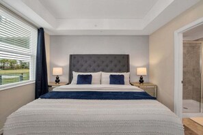 Our master bedroom features a king-size bed, TV, and private bathroom, perfect for relaxing after a long day at the parks.