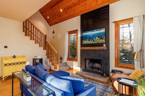 Main living area featuring Samsung Frame TV and wood burning fire place