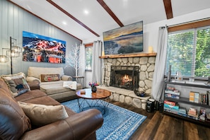 Cozy up to the fire in our oversized chair, comfortable sofa and 65" TV.