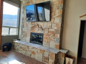 Warm up next to the stone fireplace with Smart tv and cable