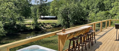 Hot tub with a bar overlooking the river. 