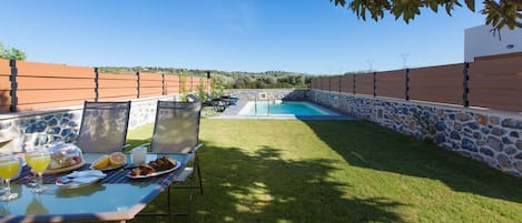 Private swimming pool area and outdoor dining area