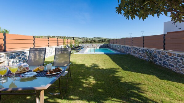 Private swimming pool area and outdoor dining area