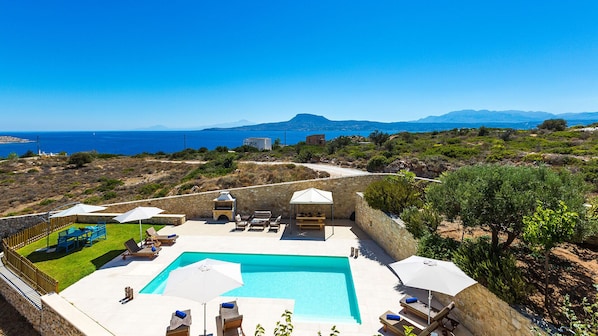 Outdoor area with 35 sqm pool, sun beds, seating areas and amazing views of Souda Bay