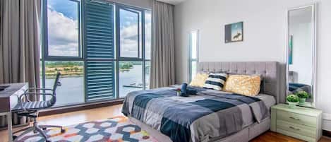 Wake up with a beautiful view! The master bedroom with a queen-sized bed and plush pillows.