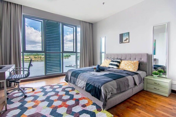 Wake up with a beautiful view! The master bedroom with a queen-sized bed and plush pillows.