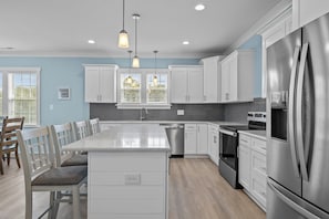 Large Kitchen island offers additional seating for four