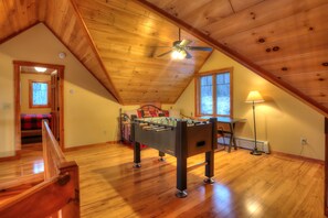 Upper level loft bedroom with One Twin daybed and a foosball table