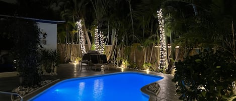 Relaxing outdoors space with landscaping lights throughout 