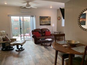 Living room, and dining area.  Slidling glass door leads to walled in private patio, near pool area.