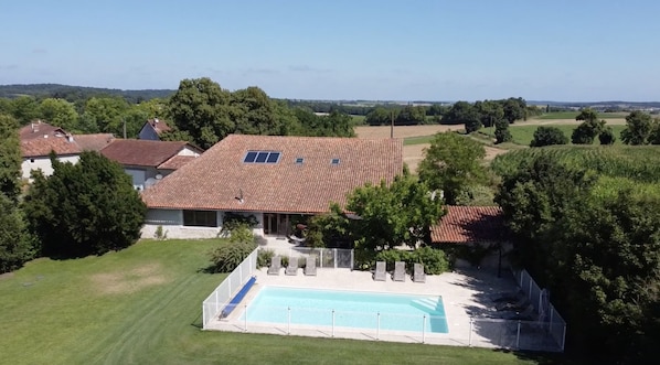 Aerial view of house and pool (and farm buildings).