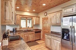 In The Snow Lodge kitchen with stainless Steel appliances.