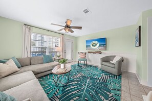 Our comfortable living area has room to spread out after a long day at the beach. Watch TV or a DVD on our 55 inch smart TV.