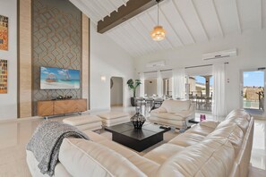 Step into our spacious living room, where soaring ceilings create an atmosphere of grandeur and elegance.