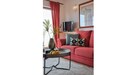 The light and airy living room features a comfortable seating area as well as a dining area with space for up to 6 people