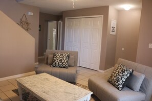 Downstairs' living room, equipped with two single size futon chairs