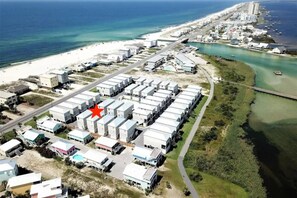 A bird's-eye view of the community reveals a beachfront and Little Lagoon at the rear. Our prime location ensures convenient access to both the beach and lagoon, creating an ideal setting for a relaxing and unforgettable vacation.