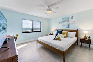 Master bedroom with a king bed and big screen TV.