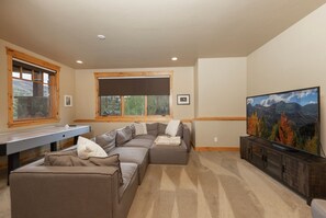 Basement family room with smart TV, air hockey table and access to the private hot tub.