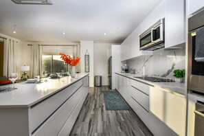 Polished Kitchen of the 2BR condo in Noord Aruba - Fully Equipped - Storage space for organized and clutter-free counters - Smart use of space with versatile storage solutions - Thoughtful placement of kitchen essentials for easy access