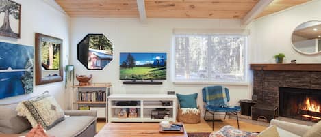 Open living space with fireplace and TV