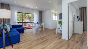 A lovely living area with a sofa-bed, cable TV, and balcony access #cozy #home #comfort #decoration