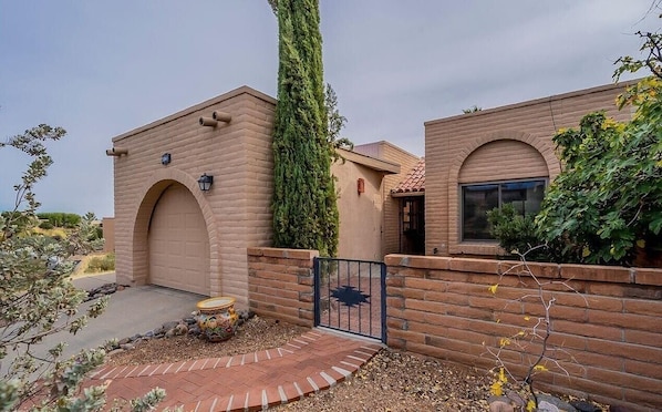 Front of house including one car garage on the left