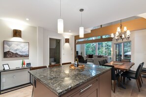Open concept layout with dining table comfortably seating 6 guests