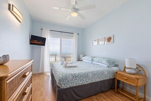 Primary bedroom with TV and ceiling fan