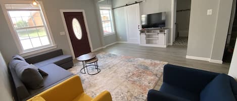 Living room w view of the laundry room and bathroom 1