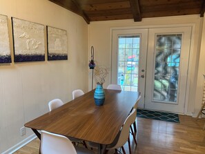 Dining table seats six. French doors open to the patio.