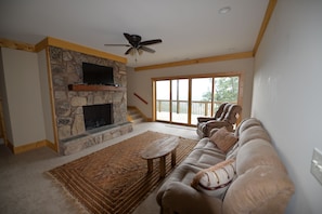 Large great room with 42 inch TV and ventless gas fireplace.