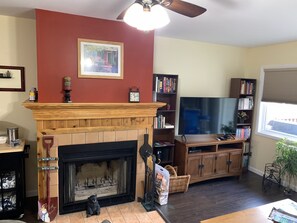 Living room.  Wood burning fireplace, TV with Cable, DVD player, books, games