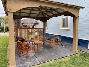 Nice outside sitting area with bbq and gas fire pit under the gazebo!